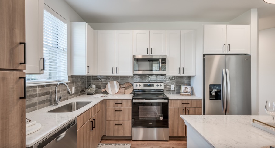 Multi-family kitchen — Savoy White Satin uppers with Midway Driftwood bases