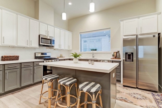 Canyon painted TruWhite wall cabinetry with Mid Grey bases and island