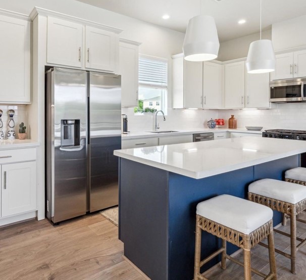 Canyon painted TruWhite cabinetry with a Midnight Navy island
